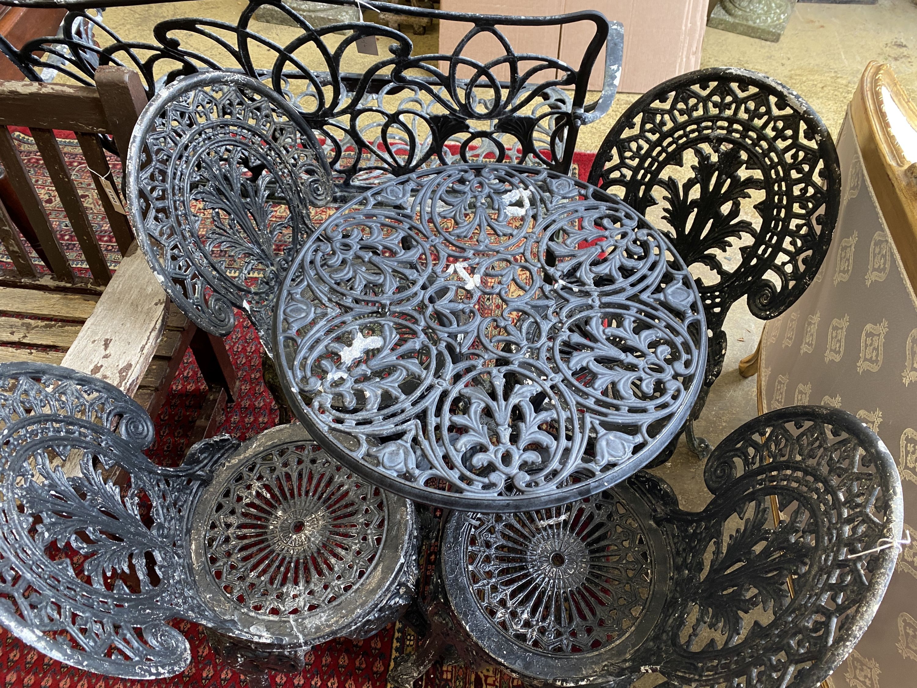 A painted aluminium circular garden table, diameter 60cm together with four aluminium garden chairs